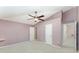 Cozy bedroom with vaulted ceilings, a ceiling fan, neutral carpet, and an en-suite bathroom at 2076 Whispering Trails Blvd, Winter Haven, FL 33884