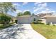 Charming single-story home with a well-maintained lawn and a two-car garage at 2076 Whispering Trails Blvd, Winter Haven, FL 33884