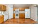 Kitchen featuring white appliances, wood cabinets, and vinyl flooring at 2076 Whispering Trails Blvd, Winter Haven, FL 33884