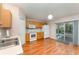 Kitchen featuring modern wood floors, white appliances, and sliding glass doors to the lanai at 2076 Whispering Trails Blvd, Winter Haven, FL 33884