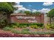 Community entrance sign with 'Whispering Trails' in decorative lettering amidst lush landscaping at 2076 Whispering Trails Blvd, Winter Haven, FL 33884