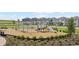 Community playground featuring play equipment, swings, and benches, set against a backdrop of residential homes at 2634 Armstrong Ave, Clermont, FL 34714