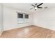 Bedroom with wood-look flooring, a modern ceiling fan, and window with blinds at 265 Elderberry Dr, Davenport, FL 33897