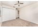 A bedroom featuring neutral carpet, a ceiling fan, and a closet with double doors at 265 Elderberry Dr, Davenport, FL 33897