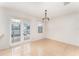 Dining area with tile floors, double doors to backyard, and modern chandelier at 265 Elderberry Dr, Davenport, FL 33897