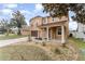 Two-story home with front yard landscaping, covered entrance, and a two-car garage at 265 Elderberry Dr, Davenport, FL 33897