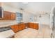 Well-lit kitchen with wood cabinets, stainless steel appliances, and tile flooring at 265 Elderberry Dr, Davenport, FL 33897