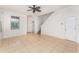 Bright and airy living room featuring tile flooring and a staircase to the upper level at 265 Elderberry Dr, Davenport, FL 33897