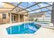 Backyard pool with screened enclosure and hot tub, adjacent to the home at 265 Elderberry Dr, Davenport, FL 33897