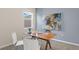 Home office with modern decor, a stylish desk setup, and a large abstract painting at 2938 Haze Rd, Clermont, FL 34714