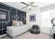 Stylized bedroom featuring a modern daybed, unique chalkboard wall design, and comfortable furnishings at 5645 Meditation Dr, Clermont, FL 34714