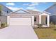 Charming single Gathering home with a two car garage and a well-manicured lawn at 1776 Frogmore Ave, Haines City, FL 33844