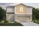Charming two-story home with a two-car garage, landscaped yard, and modern design elements at 1780 Frogmore Ave, Haines City, FL 33844