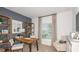 Home office with a wooden desk, built-in shelves, and natural light from a window with curtains at 1920 Rosewood Cir, Lakeland, FL 33810