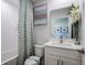 Bright bathroom with decorative shower curtain, tub, and single vanity sink at 1018 Brimstone Cir, Winter Haven, FL 33884