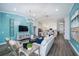 Bright, open-concept living space with stylish light blue accent wall connecting the living room and dining area at 1018 Brimstone Cir, Winter Haven, FL 33884