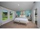 Bright bedroom with paneled accent wall, carpet, and windows with view overlooking the landscape at 1018 Brimstone Cir, Winter Haven, FL 33884