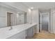 Bathroom featuring double sinks, a large mirror, and vinyl flooring at 1018 Foreshore Ln, Haines City, FL 33844