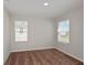 Bedroom featuring neutral color palette with two bright windows and plush carpeting at 1018 Foreshore Ln, Haines City, FL 33844
