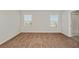 Cozy bedroom featuring neutral walls, plush carpeting, and bright windows with neighborhood views at 1018 Foreshore Ln, Haines City, FL 33844