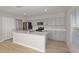 Modern kitchen with stainless steel appliances, gray cabinets, and a large center island at 1018 Foreshore Ln, Haines City, FL 33844