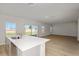 Bright and airy living room and kitchen area with wood-look floors and lots of natural light at 1018 Foreshore Ln, Haines City, FL 33844
