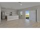 Open concept living area featuring wood-look floors and sliding glass doors to the backyard at 1018 Foreshore Ln, Haines City, FL 33844