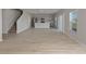 Spacious living area with light wood floors, adjacent to modern kitchen with stainless steel appliances at 1018 Foreshore Ln, Haines City, FL 33844