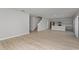 Open-concept living room and kitchen with light wood floors, gray cabinets and stainless steel appliances at 1018 Foreshore Ln, Haines City, FL 33844