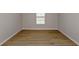 Versatile room with plank floors, neutral walls, base molding, and a window at 1018 Foreshore Ln, Haines City, FL 33844