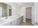 Bathroom features a dual sink vanity with quartz countertops, grey cabinetry, and modern fixtures at 1026 Foreshore Ln, Haines City, FL 33844