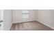 Bedroom featuring neutral walls, plush carpet, base trim, and abundant natural light from the large window at 1026 Foreshore Ln, Haines City, FL 33844