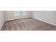 Bright bedroom featuring neutral walls, plush carpet, base trim, and abundant natural light through two large windows at 1026 Foreshore Ln, Haines City, FL 33844