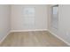 Bright bedroom featuring wood floors, neutral walls, and large windows with blinds at 1026 Foreshore Ln, Haines City, FL 33844
