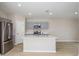 Modern kitchen with stainless steel appliances, gray cabinets, an island, and sleek countertops at 1026 Foreshore Ln, Haines City, FL 33844