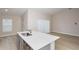 Open concept kitchen with a central island and views of the living area, enhancing the home's entertaining space at 1026 Foreshore Ln, Haines City, FL 33844