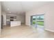 Open-concept living space featuring light wood floors, neutral walls and access to the patio through sliding glass doors at 1026 Foreshore Ln, Haines City, FL 33844
