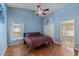 This spacious bedroom includes a ceiling fan, a closet, and an en-suite bathroom at 112 Thorne Meadow Pass, Davenport, FL 33897
