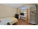This bedroom features beautiful wood floors, a large window and a spacious closet at 112 Thorne Meadow Pass, Davenport, FL 33897