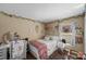 This charming bedroom is decorated with wall decor, string lights and a decorative window at 112 Thorne Meadow Pass, Davenport, FL 33897