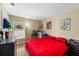 This bedroom features a desk, closet, wood floors and large window at 112 Thorne Meadow Pass, Davenport, FL 33897