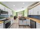 Bright kitchen featuring modern appliances, butcher block counters, and stainless steel sink at 112 Thorne Meadow Pass, Davenport, FL 33897