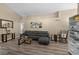 Comfortable living room offering a modern aesthetic with hardwood floors and a large sofa at 112 Thorne Meadow Pass, Davenport, FL 33897