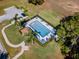 Aerial view of a community swimming pool with lounge chairs and lush landscaping at 112 Thorne Meadow Pass, Davenport, FL 33897