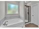 Elegant bathroom featuring a soaking tub and tiled shower at 17745 Sw 25Th Ave Rd, Ocala, FL 34473