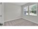 Cozy bedroom with plush carpeting and large double window at 17745 Sw 25Th Ave Rd, Ocala, FL 34473
