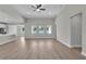 Bright, open-concept living room with hardwood flooring and modern ceiling fan at 17745 Sw 25Th Ave Rd, Ocala, FL 34473