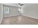 Spacious main bedroom featuring hard wood floors, two windows and a ceiling fan at 17745 Sw 25Th Ave Rd, Ocala, FL 34473