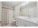 Bright bathroom featuring white vanity, mirror, and tub with shower at 2047 Rosewood Cir, Lakeland, FL 33810