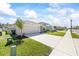 A single-Gathering home shows a two-car garage, landscaping and a concrete driveway at 2047 Rosewood Cir, Lakeland, FL 33810